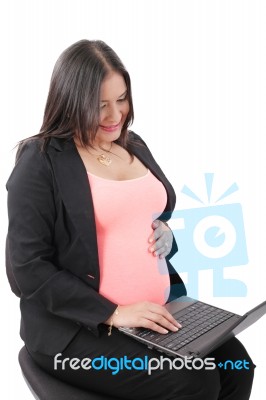 Pregnant Businesswoman Working At Laptop Stock Photo