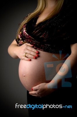 Pregnant Lady Holding Her Tummy Stock Photo