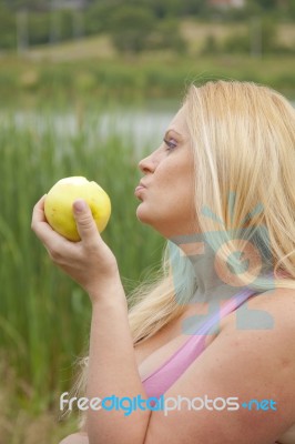 Pregnant Woman Eating Apple Stock Photo