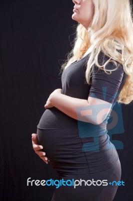 Pregnant Woman Holding Tummy Stock Photo