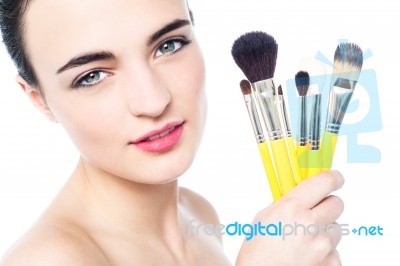 Pretty Girl With Makeup Brushes Near Her Face Stock Photo