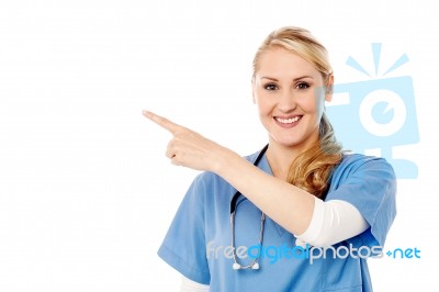 Pretty Lady Doctor Pointing Away Stock Photo
