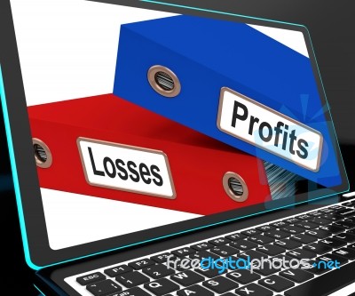 Profit And Looses Files On Laptop Showing Risky Trading Stock Image