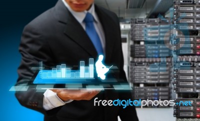 Programmer With Digital Tablet And Business Plant Stock Photo