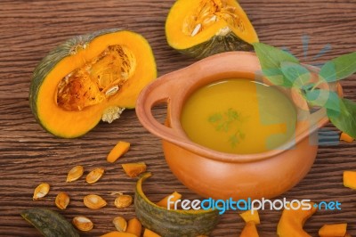 Pumpkin Soup In Clay Pot With Fresh Pumpkins Stock Photo