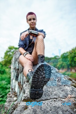 Punk Girl Sitting On A Stone Wall Stock Photo