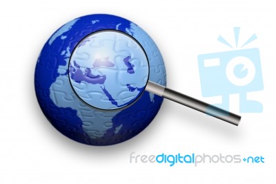 Puzzle Globe And Magnifying Glass Stock Image