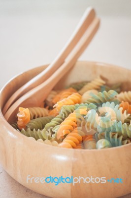 Raw Fusilli Pasta In Wooden Bowl Stock Photo