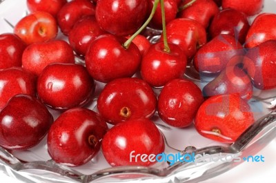 Red Cherries In A Dish Of Water Stock Photo