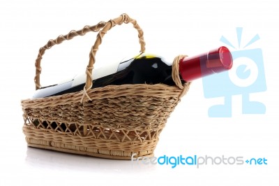 Red Wine Bottle in Bamboo Basket Stock Photo