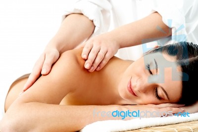 Relaxed Young Woman Enjoying Body Massage Stock Photo