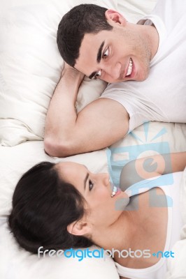 Romantic Couple Lying In Bed Stock Photo
