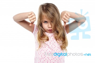 Sad Faced Girl Gesturing Thumbs Down Stock Photo