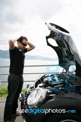 Sad Man Looking At His Broken Car Stock Photo