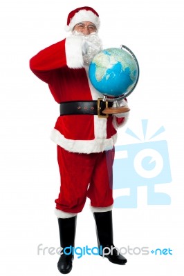 Santa Pointing Out A Continent On Globe Stock Photo