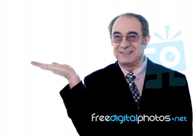 Senior Boss Posing With Open Palm Stock Photo