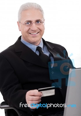 Senior Business Man Making Online Purchase With His Credit Card Stock Photo