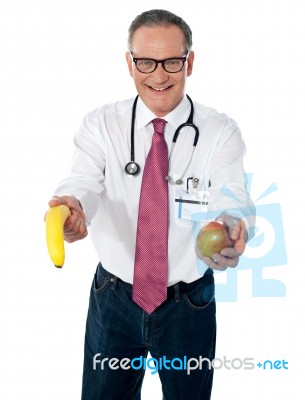 Senior Doctor Holding Fruits Stock Photo