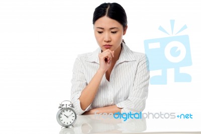 Serious Business Lady Staring At Alarm Clock Stock Photo