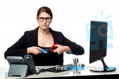 Serious Faced Woman Cutting Her Credit Card Stock Photo