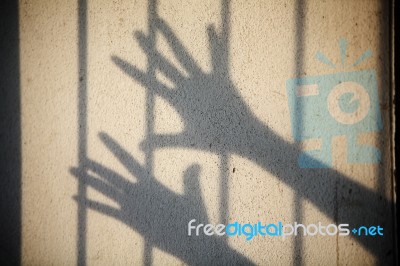 Shadow Of Hand In Jail Stock Photo