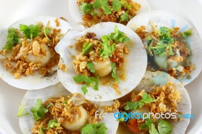 Shell Sea Food In Fried Garlic And Parsley Stock Photo