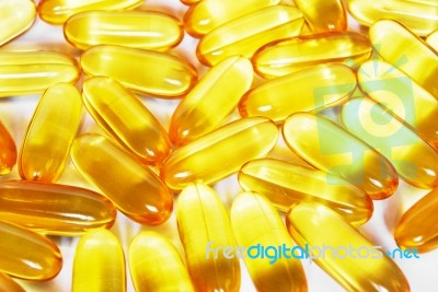 Shiny Yellow Fish Oil Capsule Pills Close Up Stock Photo