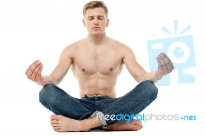 Shirtless Young Man Doing Meditation Stock Photo