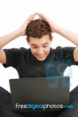 Shocked Young Man With Laptop Stock Photo