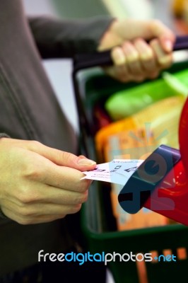 Shopper Taking Ticket For Service Stock Photo