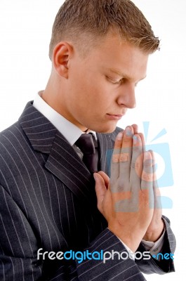 Side Pose Of Praying Businessman Stock Photo