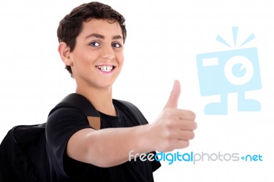 Side Pose Of Teenager Shows Thumbs Up Stock Photo