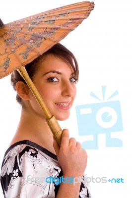 Side View Of Smiling Chineese Woman Holding An Umbrella Stock Photo