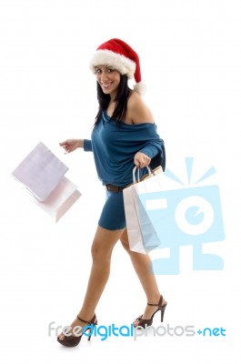 Side View Of Smiling Christmas Female Holding Carry Bags Stock Photo