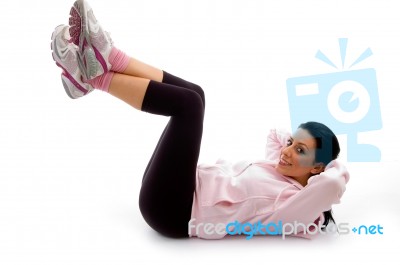 Side View Of Smiling Exercising Female On White Background Stock Photo