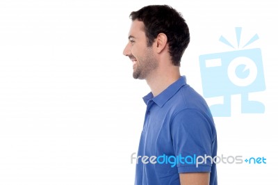 Side View Posing Of Smiling Guy Stock Photo