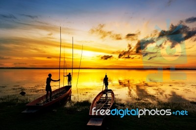 Silhouette Of Children On Boat  Stock Photo