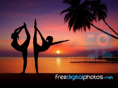 Silhouette Of Yoga Girls In Sunset Stock Image