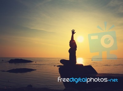 Silhouette Yoga Girl By The Beach At Sunrise Stock Photo