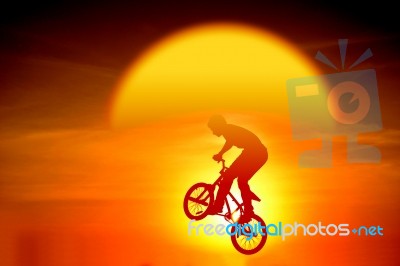 Silhouetted Bicycle Rider Stock Photo