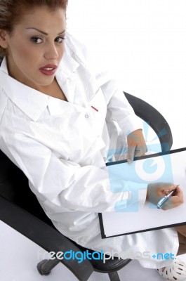 Sitting Doctor With Writing Board Stock Photo