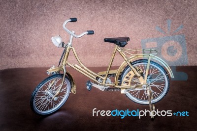 Small Gold Color Toy Bicycle Stock Photo