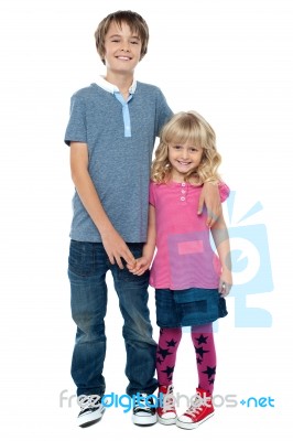 Smart Boy Holding Cute Sisters Hand And Embracing Her Stock Photo