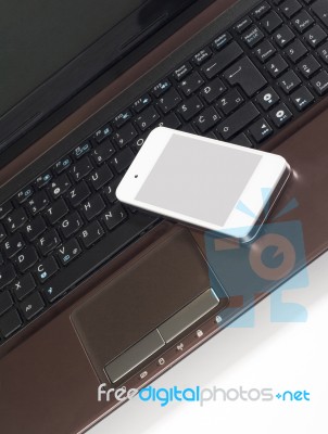 Smart Phone On The Laptop Stock Photo