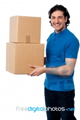 Smart Young Man Carrying Boxes Stock Photo