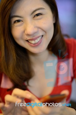 Smile Asian Woman Have Fun With Mobile Phone Stock Photo