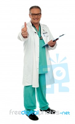 Smiling Aged Doctor With Thumb Up Stock Photo
