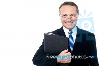 Smiling Businessman Holding File Folders Stock Photo