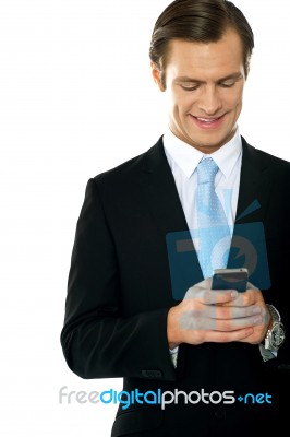 Smiling Businessperson Messaging Stock Photo