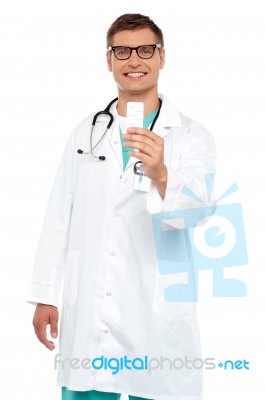 Smiling Doctor Showing Tablets Stock Photo